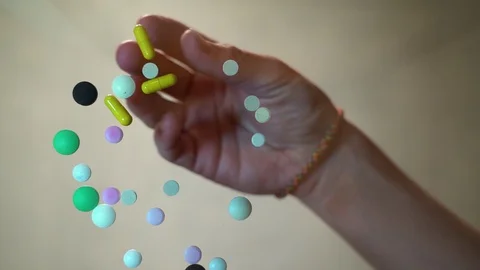 Hand collecting of pills on the table close up, bottom view. drugs Video stock 128451049