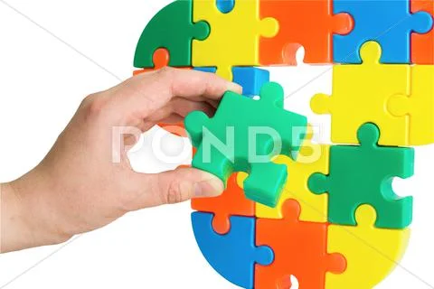 Hand with color puzzle Stock Photos