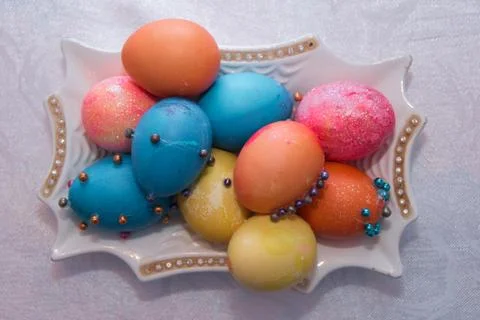 Hand colored Easter eggs on vintage plate.Many Colorful Easter Eggs On White  Stock Photos
