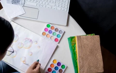 Hand coloring bubble drawing with colored watercolors in a sketchbook Stock Photos