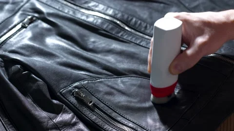Hand coloring leather jacket with black paint Stock Footage 239003147