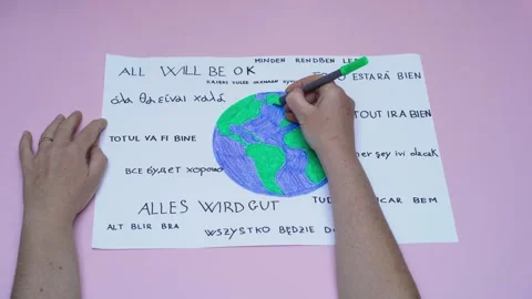 Hand coloring world drawing with 'all will be ok' motto for global unity Видео 279436866