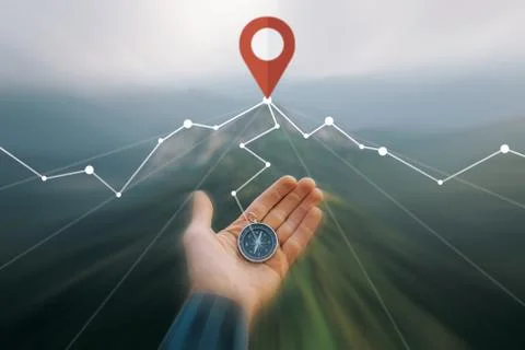 Hand with compass in the mountains. Stock Photos