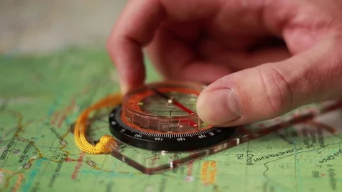Hand with compass on the topographical map 動画素材 73505661