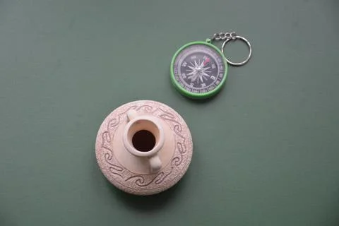 Hand compass for travel on the background of objects Stock Photos