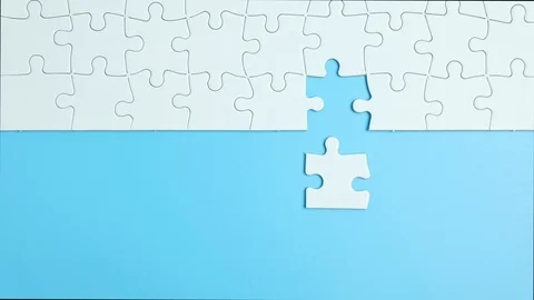 Hand complete the last piece white puzzle for business design Stock Footage 124239577