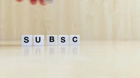 A hand composing the word subscribe with letters Stock Footage 246608796