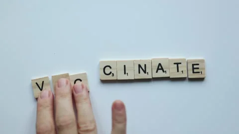 Hand composing word vaccinate on white background. vaccine stop covid Stock Footage 157678749