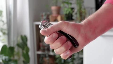 Hand compressing spring expander hand grip exerciser with tension. Arm training Stock Footage 315344094