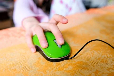 Hand on a computer mouse. The child's hand guides learning with technology Stock Photos