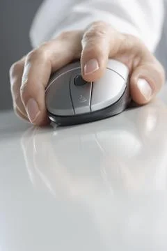 Hand on computer mouse with reflection 写真素材