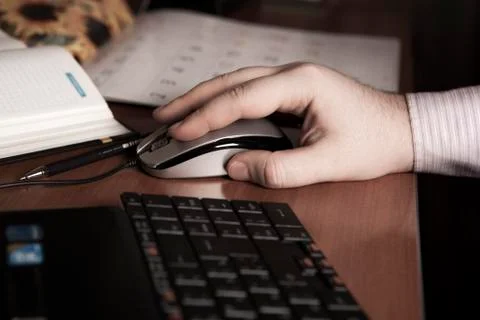 Hand on a computer mouse at work Stock Photos