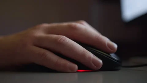Hand on a computer mouse, works in the evening behind the monitor, backlight Stock Footage 153700347