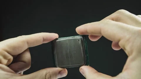 Hand of computer repairman holds computer cpu processor Stock Footage 166046094