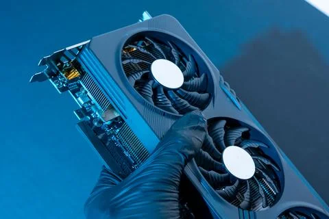 Hand of a computer technician holds a modern powerful video game card 库存照片