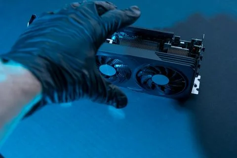 Hand of a computer technician holds a modern powerful video game card Foto stock