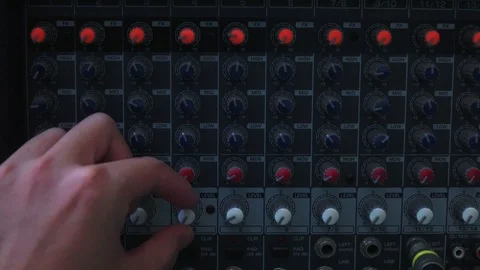 Hand configured many knobs on analog mixer Video stock 87910899