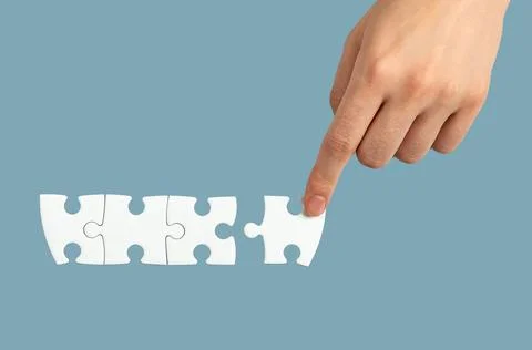 Hand connecting, adding puzzle piece, final touch concept Stock Photos
