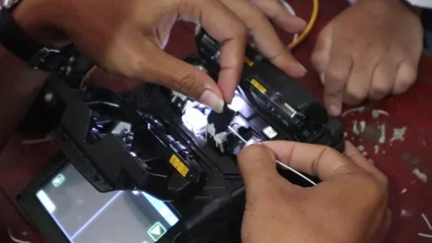 Hand connecting fiber optic cables, cutting fiber optic cables for internet Stock Footage 307371167