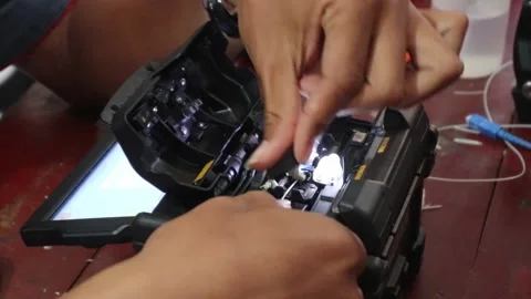 Hand connecting fiber optic cables, cutting fiber optic cables for internet Stock Footage 307371168
