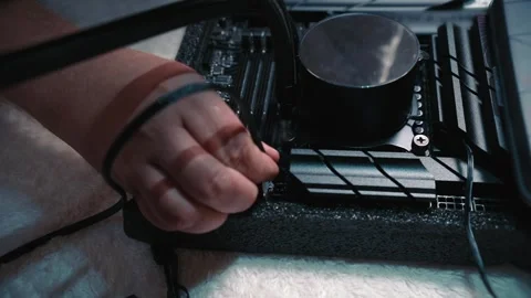 Hand connecting water cooling cable to motherboard socket Stock Footage 324593158