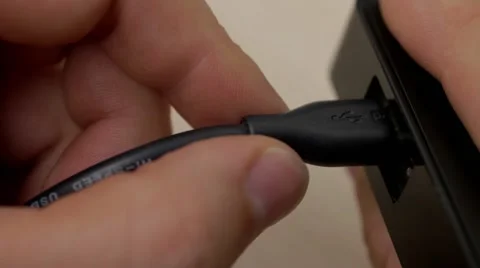 A hand connects micro USB cable to external device Stock Footage 54354285
