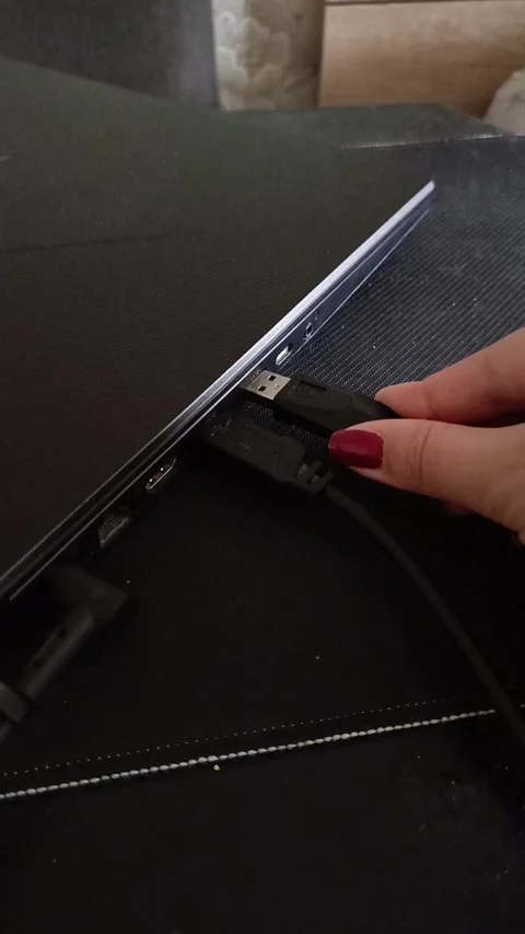 The hand connects the usb cable to the laptop. Connecting the Internet, mouse Stock Footage 319980583