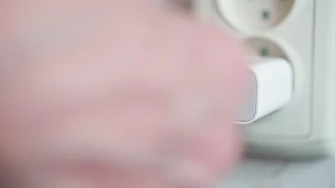 Hand connects usb cable with plug to star charging a device. Electricity. Video stock 153557234