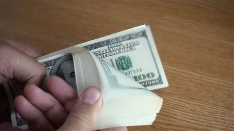 Hand considers a dollar bills in slow motion Stock Footage 137328700
