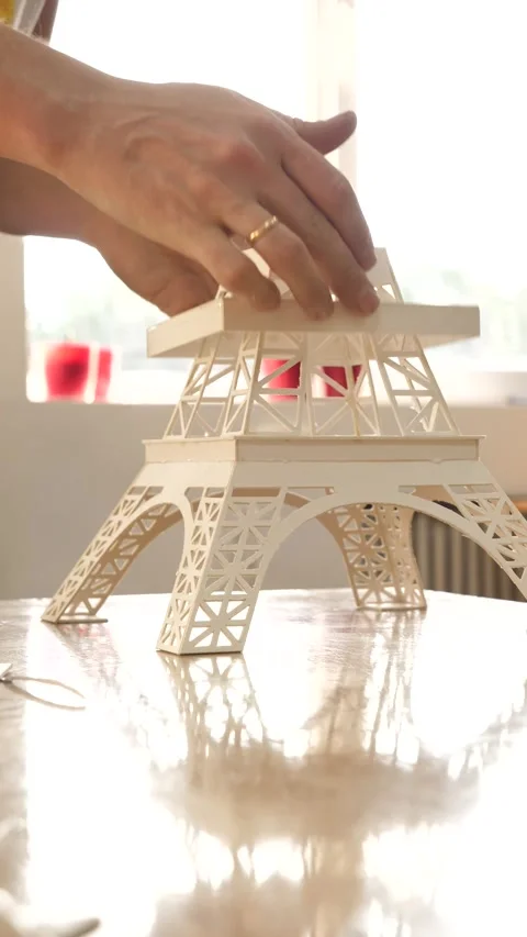 Hand construct paper Eiffel tower, close-up hand building the Eiffel tower Stock Footage 252138849