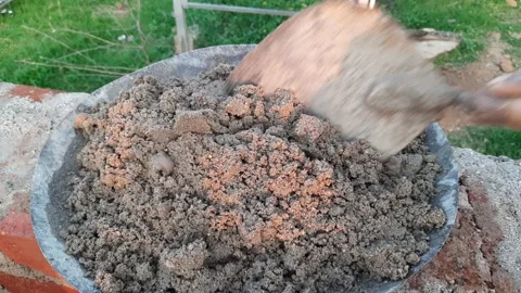 Hand of a construction worker mixing cement and sand with a shovel. Stock Footage 221544508