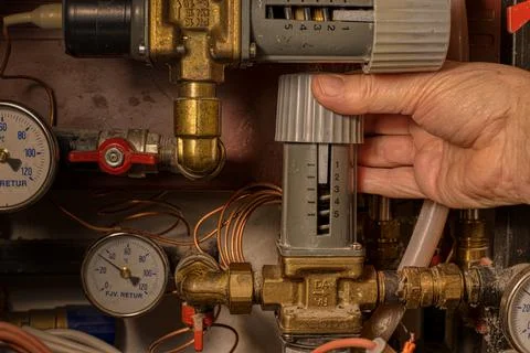 A hand on the control to a district heating system, Denmark, January 18, 2022 Stock Photos