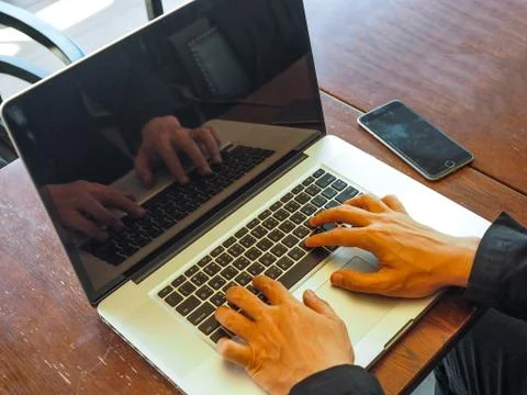Hand control on a laptop touch Stock Photos