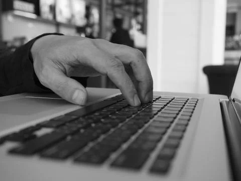 Hand control on a laptop touch Stock Photos