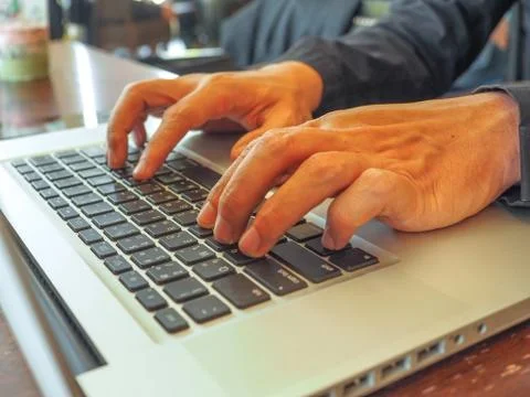 Hand control on a laptop touch Stock Photos