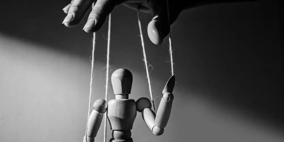 Hand that is controlling the puppet concept of influence and power. manipulation Stock Photos