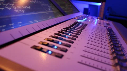 The hand controls the faders on the light console Stock Footage 231574798