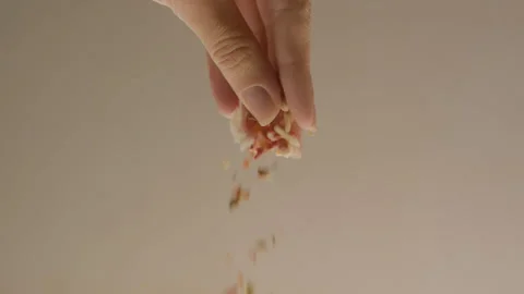 Hand of the cook cast spices in a dish on a light background Stock Footage 92199426