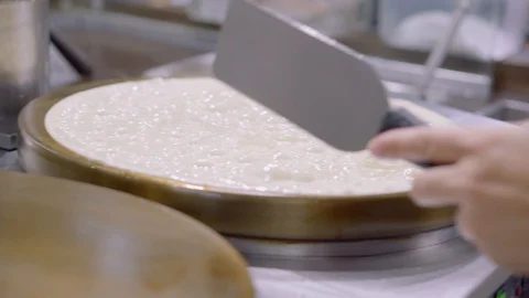 Hand of cook flips big pancake or crepes. Видео 123142009