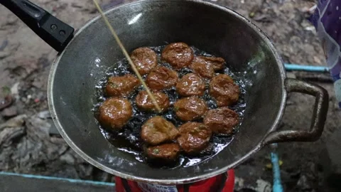 Hand cooking fried fish cake in metal and hot oil to delicious food Stock Footage 140369575