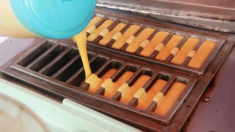 Hand cooking or making pukis cake using a special mold. Stock Footage 303649731