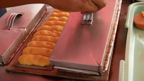 Hand cooking or making pukis cake using a special mold. Stock Footage 303649841