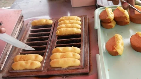 Hand cooking or making pukis cake using a special mold. Stock Footage 303649857