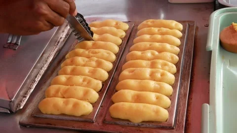 Hand cooking or making pukis cake using a special mold. Stock Footage 303649879
