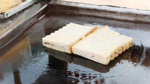 Hand cooking toast using spatula on grill Stock Footage 301599898