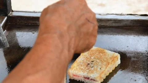 Hand cooking toast using spatula on grill Stock Footage 301600074