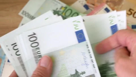 Hand counting big stack of euro money on wooden background. money cash, close Stock Footage 332795120