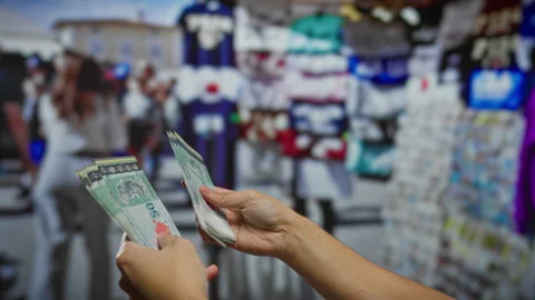 Hand counting malaysian ringgit banknotes at an outdoor souvenir shop, with.. Stock Footage 303423987