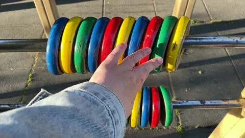 Hand counts colored rings on the playground. Stock Footage 194718204