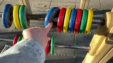 Hand counts colored rings on the playground. Stock Footage 194718227